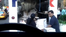 FedEx employee throwing items in truck