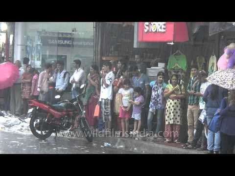 People patiently waiting under the shed to avoid getting wet