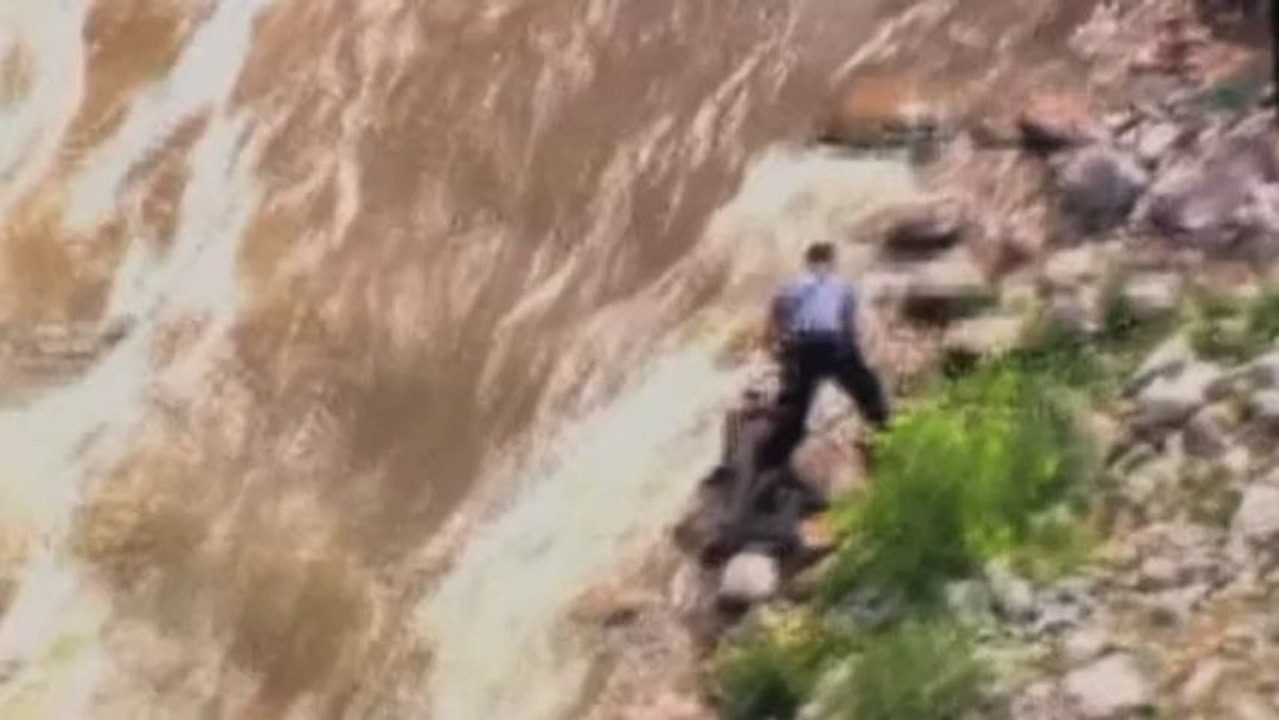 Man with fish rescued from river