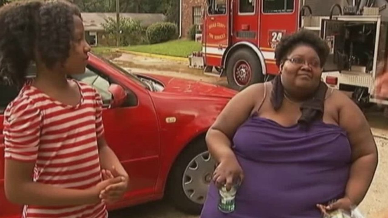 Girl catches baby from house ablaze