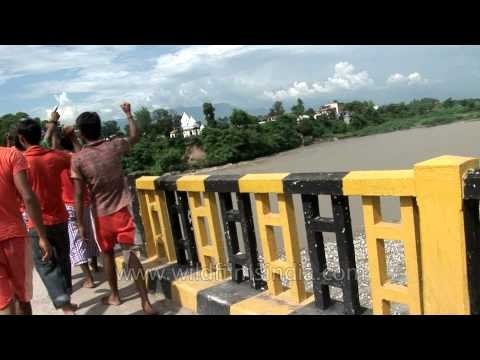 Shiv devotees crosses Ton river connnecting chanting praises of the Lord