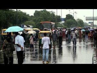 Monsoon cools down Delhi: Umbrellas gather at Safdarjung bus stop
