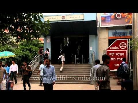 People enter and exit at the Noida Sector 15 Metro Station