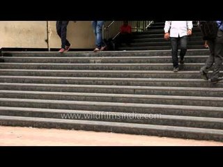 People enter and exit at the MG road Metro Station