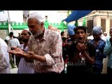 Muslim devotees performing Iftar rituals at Nizamuddin dargah