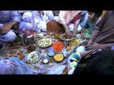 Indian Muslim family place food items on plates during Iftar