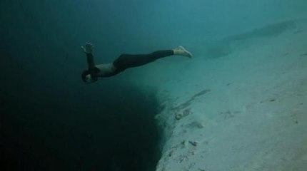 Guillaume Nery base jumping at Deans Blue Hole, filmed on breath hold by Julie Gautier