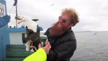 Fisherman catches a seagull mid-flight