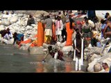 Devotees bathing and filling bottles with holy water of river Ganga in Gangotri