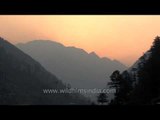 Panoramic view of sunrise from behind snow clad peaks below Gangotri