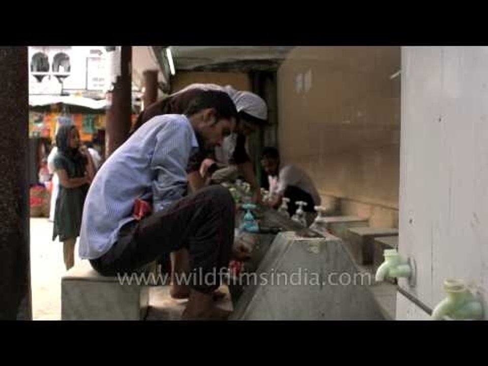 Muslim boy performing ablution before Namaz - Hazrat Nizamuddin Dargah