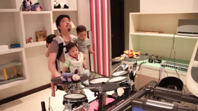 He plays drums with one hand carrying his 3 babies!! American: This or the apocalypse cover!!