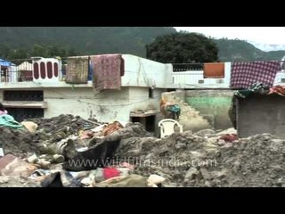 A girl sitting in the middle of the remnants of Uttarakhand flood