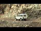 Car passing through dangerous narrow mountain road