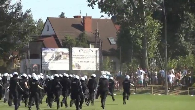 Hooligans VS police during football game.