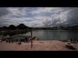 Sun beams burst through monsoon clouds at ghats of Pushkar Sagar