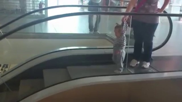 Baby walks the wrong way on moving escalator