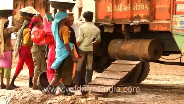 2012.workers loading salt into truck in Gujarat