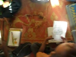 a teacher with lil kids in a rohingya language learning school  معلم يدرس الاطفال اللغة الروهنجية الرئيسية