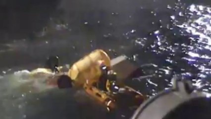 RNLI battles storm to salvage helicopter after fatal crash