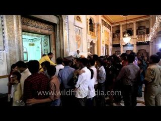 Pandit giving away prasad to all the believers