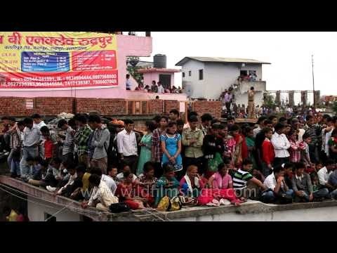 People watching stone pelting festival from roof top