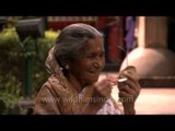 An elderly woman cleaning her spectacles