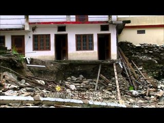 Man helplessly watching the flood water pass by