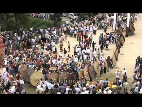 Participating in bagwal with traditional wooden shield for protection