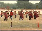 Army unit with music instrument performing a march past
