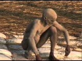 Naga sadhu cleans his ash covered body - Ardh Kumbh at Prayaga in 2007