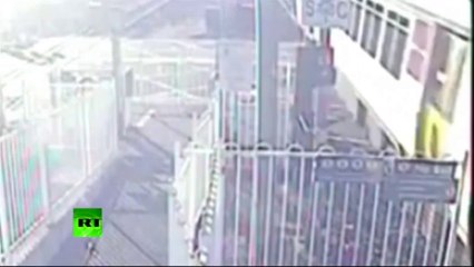 CCTV video- Near miss for man crossing train tracks in Australia