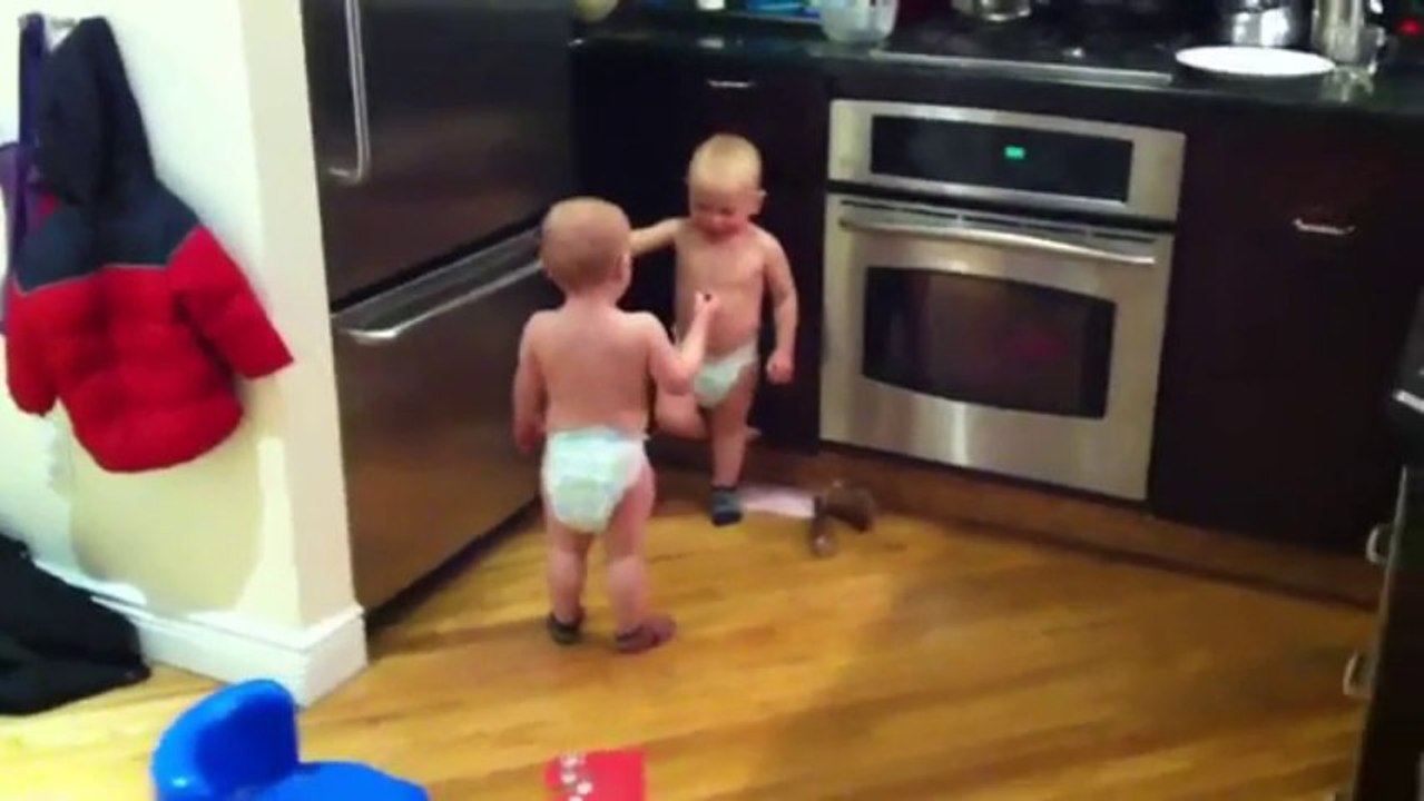 Twin baby boys having a conversation
