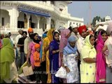 Sikh devotees pay their respects at the Sikh Shrine - Golden Temple