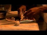 Chef prepares an Italian dish at Flavors Restaurant, Defence Colony