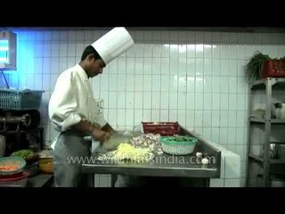 Chef chopping the vegetables: Posh hotel kitchen