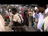 Bhisti or water-carriers supplying water to people in skin bags