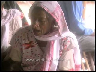Elderly woman blessing the newly weded couple in Assam