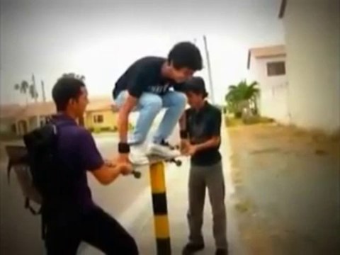 Balancing on a pole with his skateboard... Fail!!! Your Nuts!!!