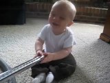 Baby can't stop laughing at vacuum!
