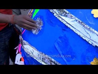 Giving a final touch by decorating the effigy of Ravana