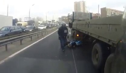 A biker almost smashed by a truck...