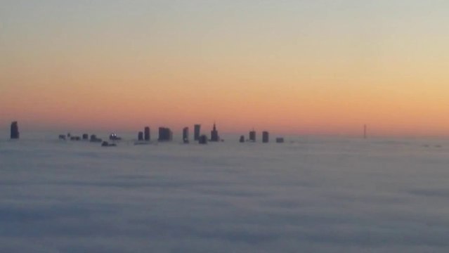 Aerial View Captures Skyscrapers Amid Fog in Warsaw