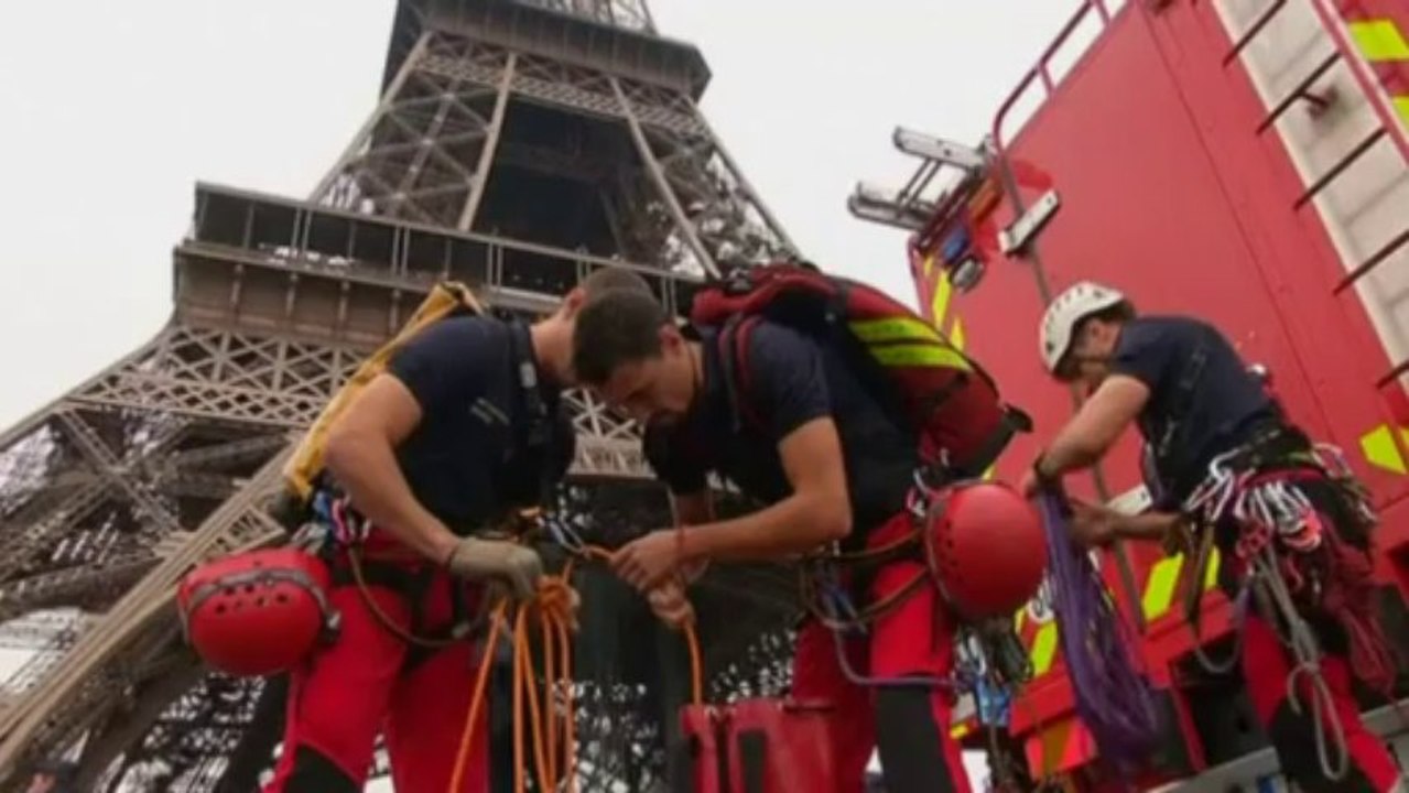 Greenpeace activist dangles from Eiffel Tower