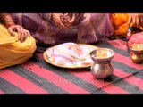 Women lighted diyas in their thalis - Karva Chauth Ritauls