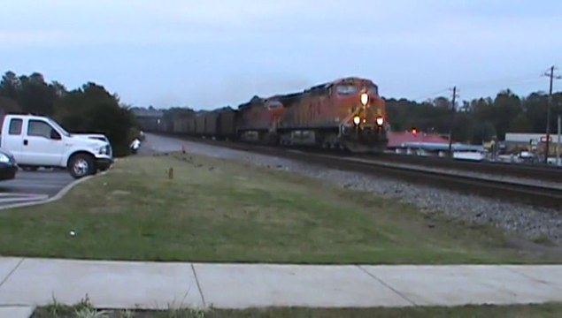BNSF power leads NS 734 coal train NB through Austell Ga.