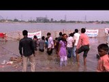 Religious or Hazardous? Durga Puja Visarjan happening at Yamuna Banks