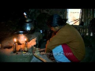 Food being cooked by tree house woman