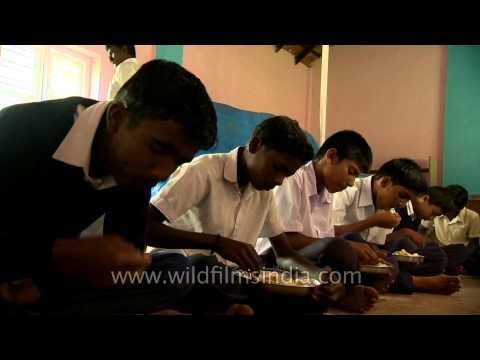 Students recite the prayer before mid-day meals provided in schools