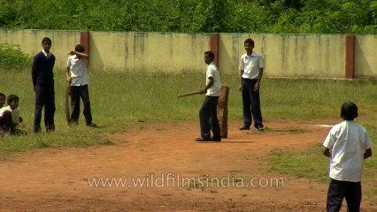 School children from South India playing cricket